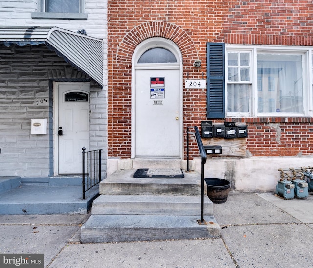 entrance to property with brick siding