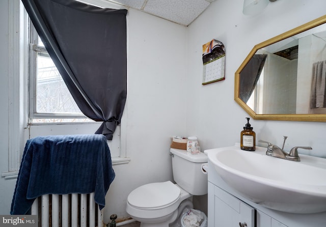 half bathroom with toilet and vanity