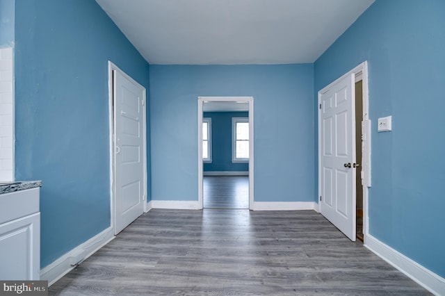 foyer with baseboards and wood finished floors