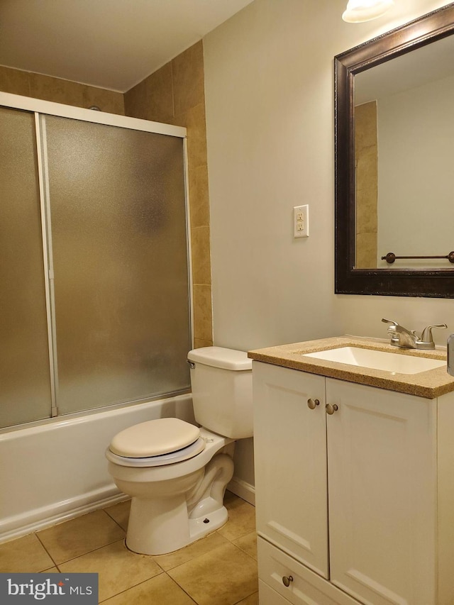 full bathroom featuring tile patterned floors, enclosed tub / shower combo, vanity, and toilet