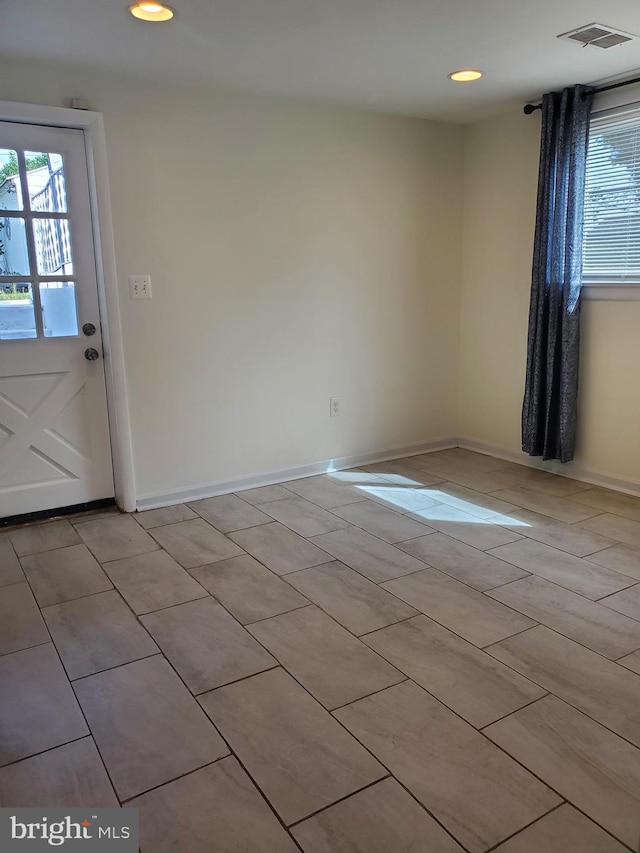 empty room featuring recessed lighting, baseboards, and visible vents