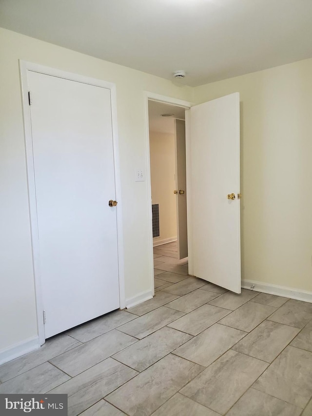 spare room with baseboards