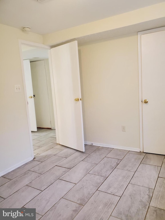 empty room featuring baseboards