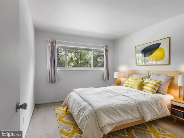 carpeted bedroom with baseboards