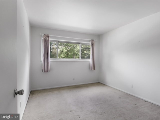carpeted empty room with baseboards