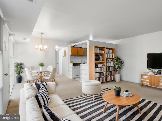 living room with a chandelier and light carpet
