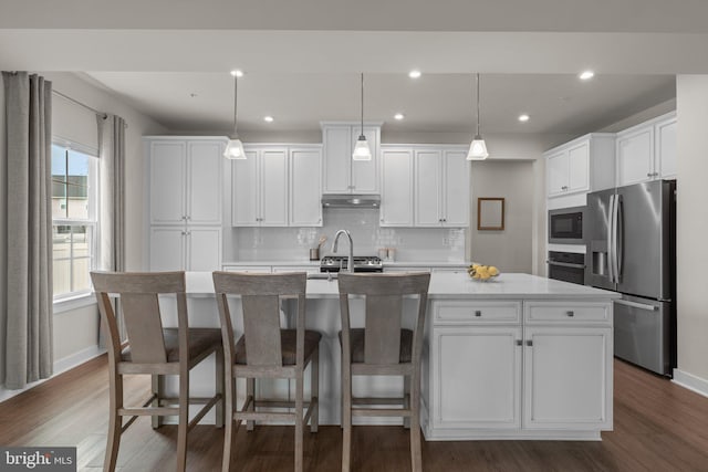 3150 Dodder Way, Odenton, MD 21113 - kitchen with stainless steel appliances, under cabinet range hood, a kitchen island with sink, dark wood-style flooring, and recessed lighting