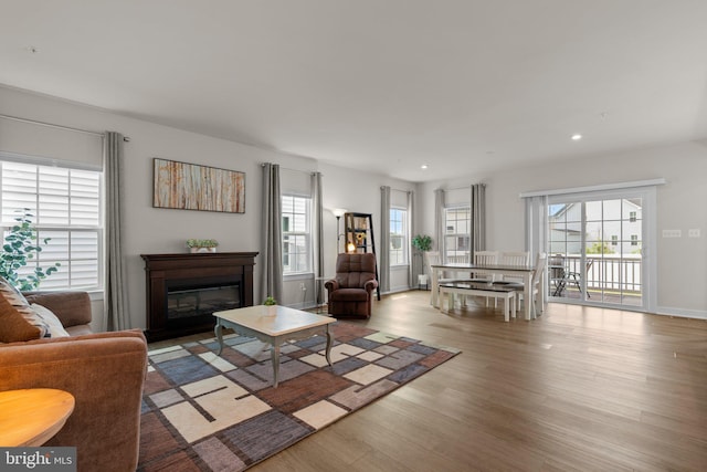 3150 Dodder Way, Odenton, MD 21113 - living area featuring plenty of natural light, wood finished floors, recessed lighting, a glass covered fireplace, and baseboards