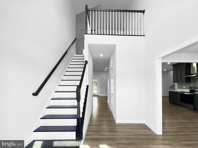 77 Iris Way, Charles Town, WV 25414 - entryway featuring stairway, a high ceiling, wood finished floors, and baseboards