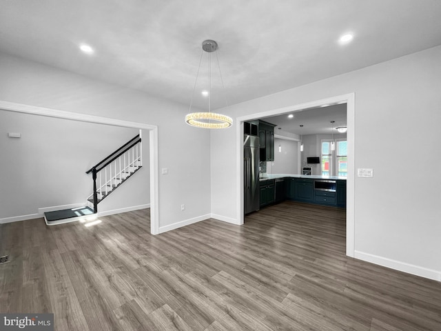 77 Iris Way, Charles Town, WV 25414 - unfurnished living room with dark wood-style floors, stairs, baseboards, and recessed lighting