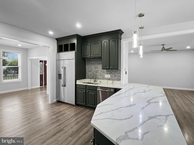 77 Iris Way, Charles Town, WV 25414 - kitchen featuring stainless steel appliances, a sink, a ceiling fan, backsplash, and wood finished floors