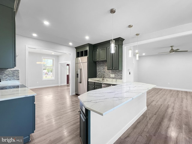 77 Iris Way, Charles Town, WV 25414 - kitchen featuring appliances with stainless steel finishes, open floor plan, a sink, ceiling fan, and light wood-type flooring