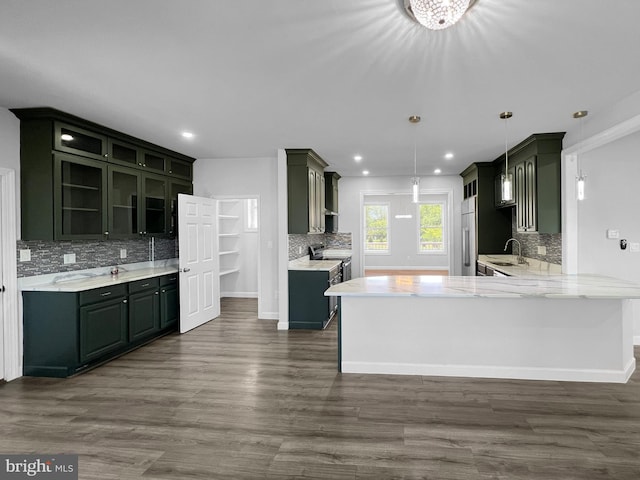 77 Iris Way, Charles Town, WV 25414 - kitchen with appliances with stainless steel finishes, backsplash, a peninsula, dark wood finished floors, and recessed lighting
