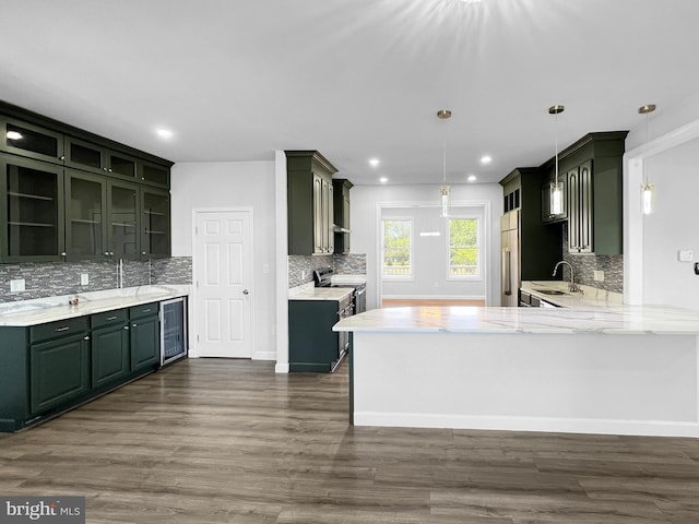 77 Iris Way, Charles Town, WV 25414 - kitchen with high quality fridge, a sink, decorative backsplash, a peninsula, and wine cooler