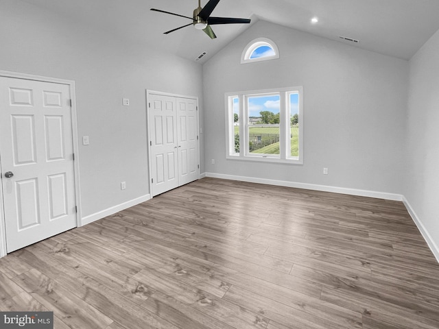 77 Iris Way, Charles Town, WV 25414 - unfurnished bedroom featuring high vaulted ceiling, baseboards, wood finished floors, and a ceiling fan