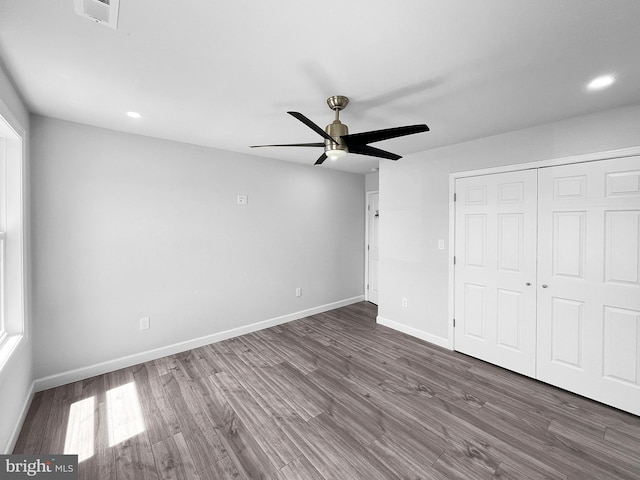 77 Iris Way, Charles Town, WV 25414 - unfurnished bedroom featuring wood finished floors, recessed lighting, a closet, baseboards, and ceiling fan