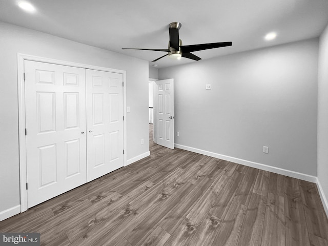 77 Iris Way, Charles Town, WV 25414 - unfurnished bedroom featuring wood finished floors, baseboards, a closet, ceiling fan, and recessed lighting