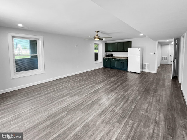 77 Iris Way, Charles Town, WV 25414 - unfurnished living room featuring ceiling fan, plenty of natural light, baseboards, and dark wood-style flooring