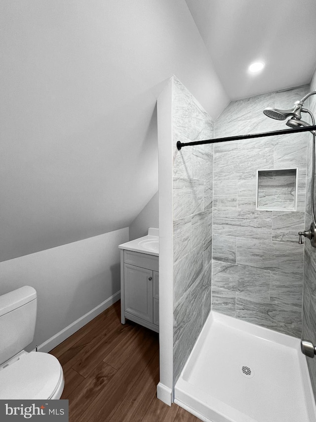 77 Iris Way, Charles Town, WV 25414 - bathroom with toilet, lofted ceiling, wood finished floors, and a stall shower