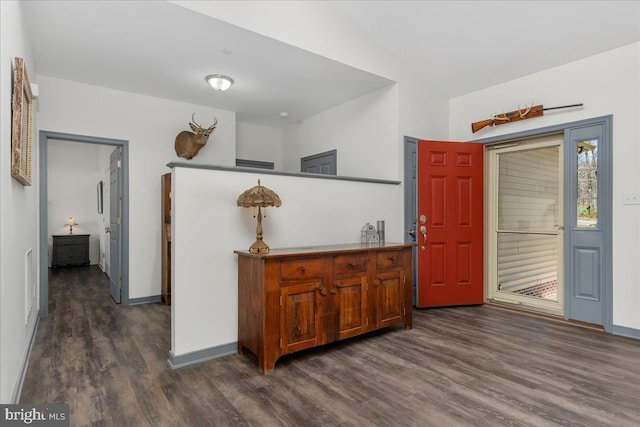 foyer entrance featuring baseboards, visible vents, vaulted ceiling, and dark wood-type flooring
