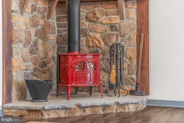 details featuring baseboards and a wood stove