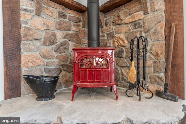 room details with a wood stove and unfinished concrete flooring