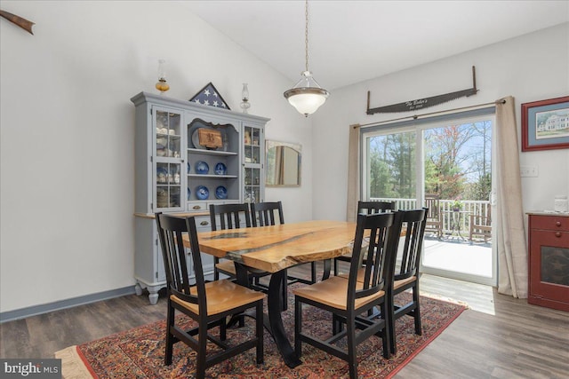 dining room with baseboards and wood finished floors