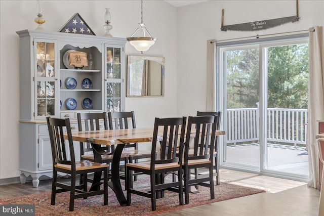 dining space with wood finished floors