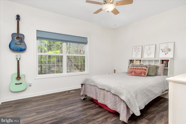 bedroom featuring baseboards, dark wood-style flooring, ceiling fan, and visible vents