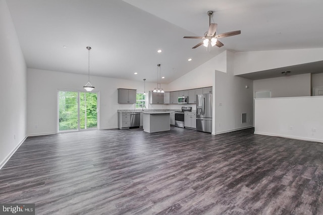unfurnished living room featuring a ceiling fan, high vaulted ceiling, dark wood-style floors, and a wealth of natural light