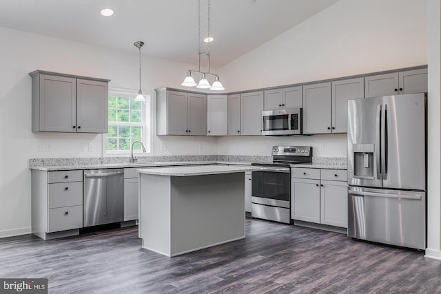 kitchen featuring hanging light fixtures, appliances with stainless steel finishes, gray cabinets, and dark wood finished floors