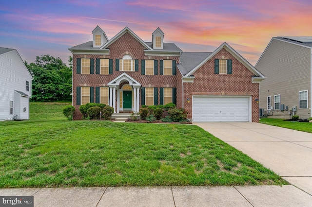 12216 Hillantrae Dr, Clinton, MD 20735 - colonial-style house featuring brick siding, concrete driveway, a front yard, and a garage