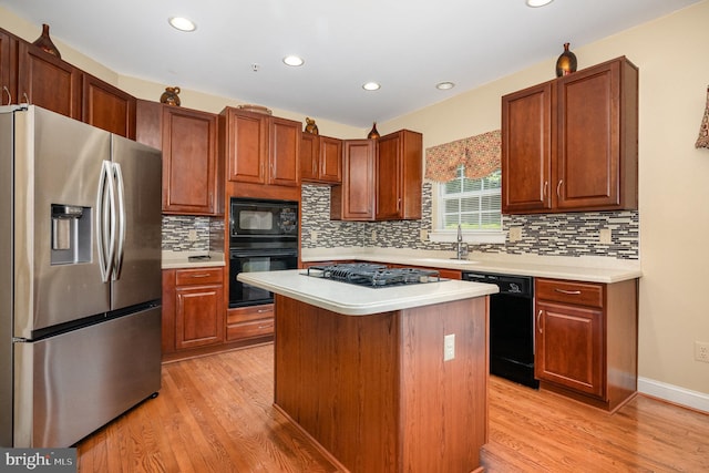 12216 Hillantrae Dr, Clinton, MD 20735 - kitchen featuring black appliances, light wood-style flooring, light countertops, tasteful backsplash, and recessed lighting