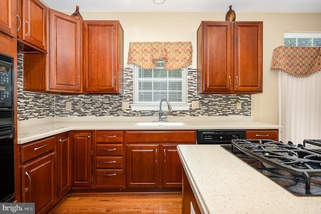 12216 Hillantrae Dr, Clinton, MD 20735 - kitchen featuring a sink, tasteful backsplash, light wood-type flooring, and black appliances