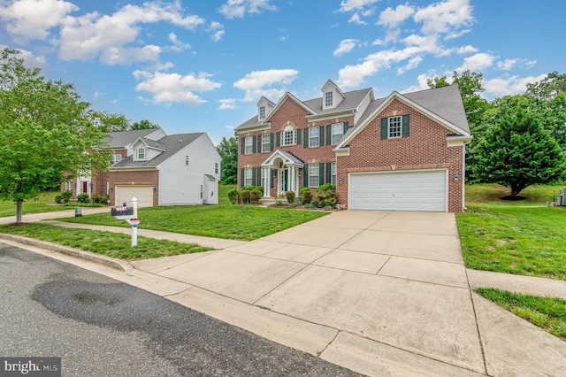 12216 Hillantrae Dr, Clinton, MD 20735 - view of front of home with brick siding, a garage, concrete driveway, and a front lawn