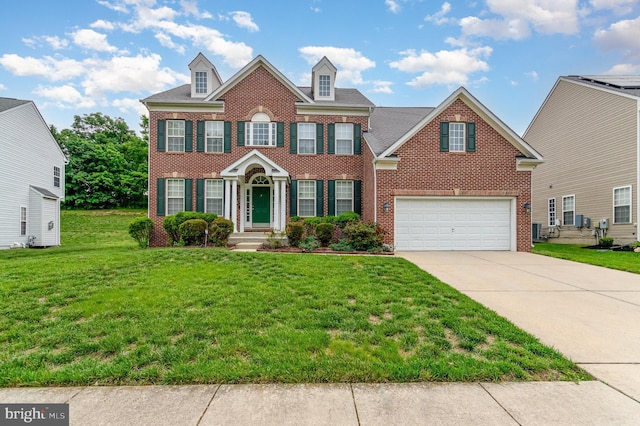 12216 Hillantrae Dr, Clinton, MD 20735 - georgian-style home with brick siding, concrete driveway, a front yard, and a garage