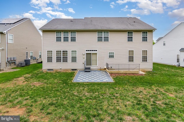 12216 Hillantrae Dr, Clinton, MD 20735 - rear view of house with a patio, a lawn, and central AC