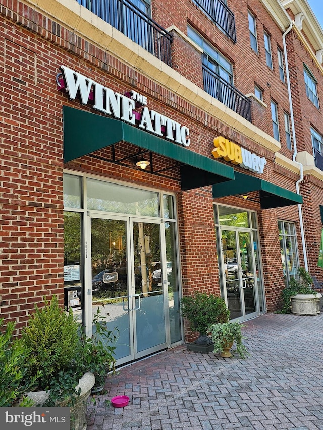 property entrance featuring brick siding