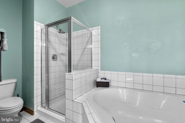 bathroom featuring a stall shower, a bath, toilet, and tile patterned floors