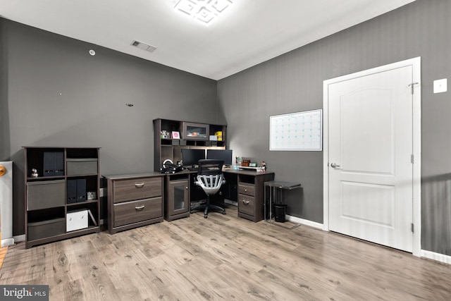 home office featuring light wood-type flooring and baseboards