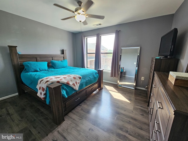 bedroom with baseboards, dark wood finished floors, and ceiling fan