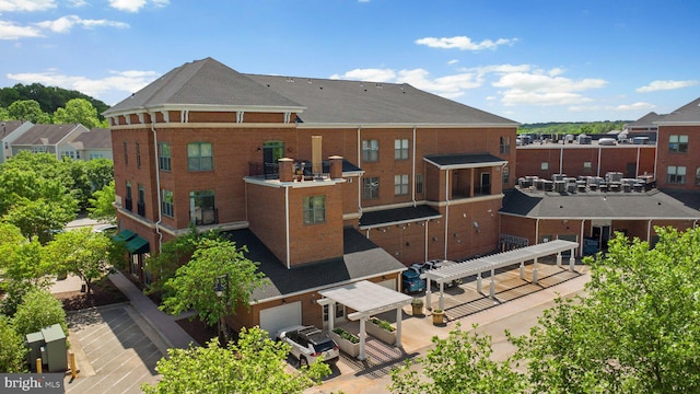 rear view of property with brick siding and a residential view