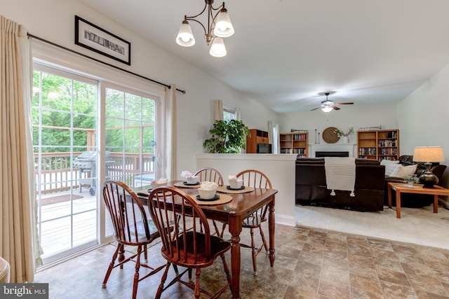 110 Trout Stream Dr, Newark, DE 19711 - dining area with a fireplace, ceiling fan, a chandelier, and stone finish flooring