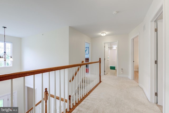 110 Trout Stream Dr, Newark, DE 19711 - hallway with an upstairs landing, a chandelier, carpet, and baseboards