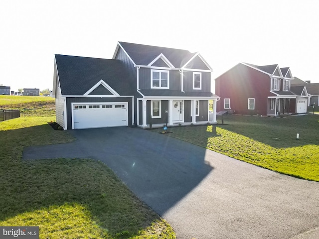 1011 Southwood Dr, Shippensburg, PA 17257 - view of front of house with driveway, a porch, an attached garage, and a front lawn