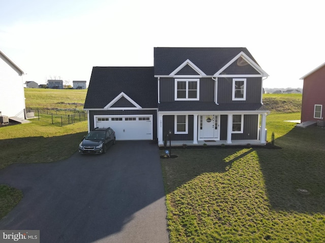 1011 Southwood Dr, Shippensburg, PA 17257 - traditional home featuring asphalt driveway, an attached garage, and covered porch