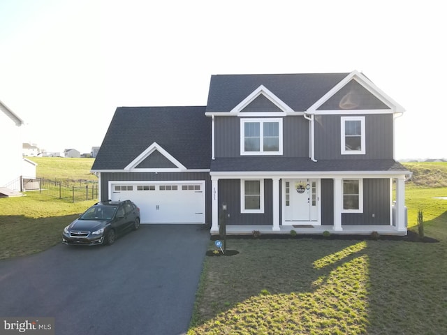 1011 Southwood Dr, Shippensburg, PA 17257 - view of front of home with asphalt driveway, an attached garage, a porch, and roof with shingles