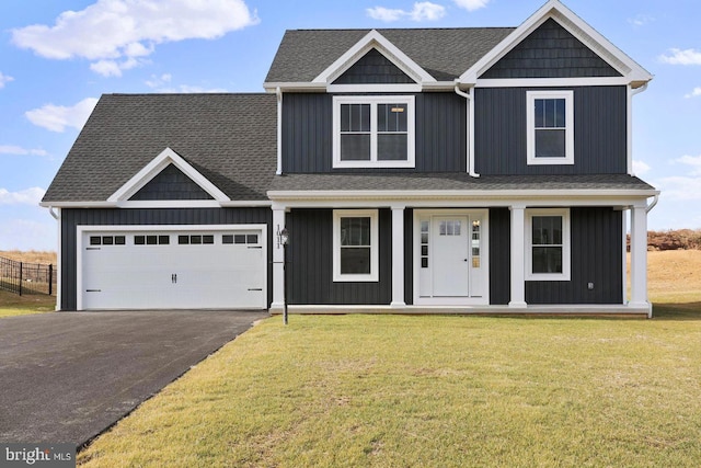1011 Southwood Dr, Shippensburg, PA 17257 - view of front facade featuring covered porch, driveway, board and batten siding, roof with shingles, and an attached garage