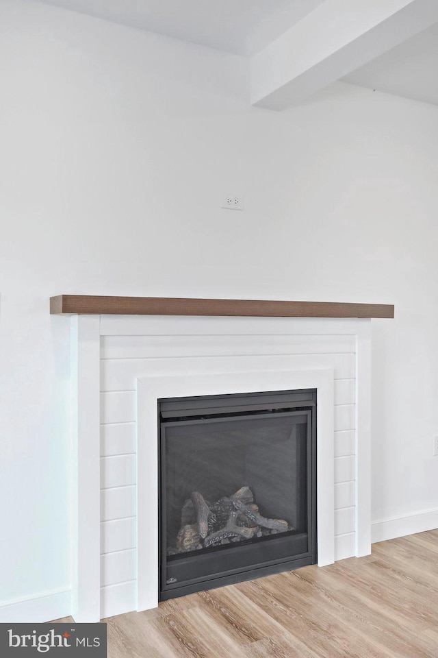 1011 Southwood Dr, Shippensburg, PA 17257 - detailed view of a glass covered fireplace, wood finished floors, and baseboards