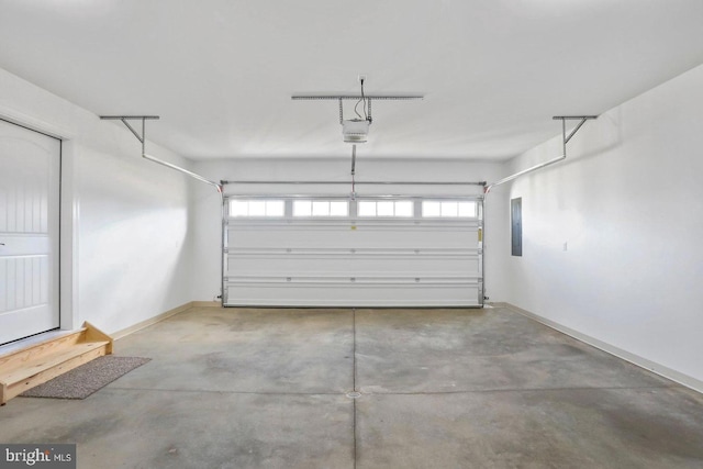 1011 Southwood Dr, Shippensburg, PA 17257 - garage featuring a garage door opener, electric panel, and baseboards